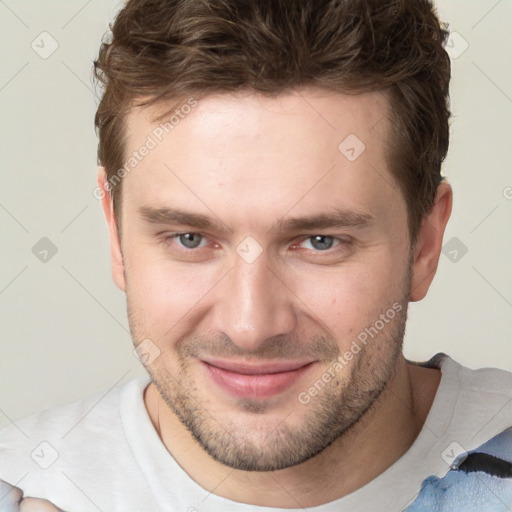 Joyful white young-adult male with short  brown hair and grey eyes