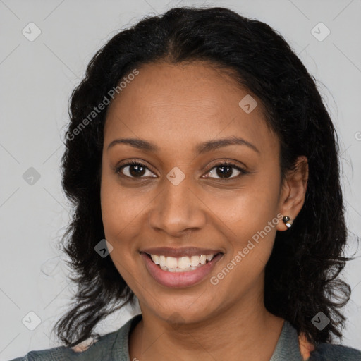 Joyful black young-adult female with long  black hair and brown eyes