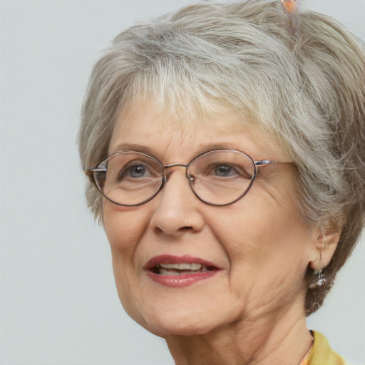 Joyful white middle-aged female with medium  gray hair and blue eyes