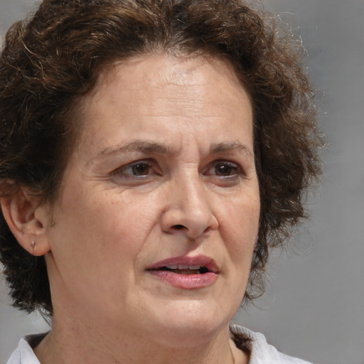 Joyful white middle-aged female with medium  brown hair and brown eyes