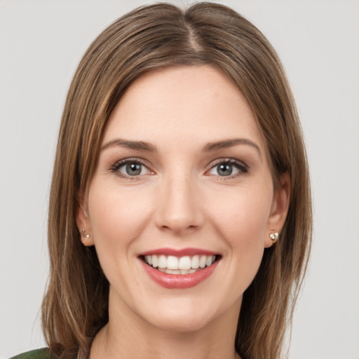 Joyful white young-adult female with medium  brown hair and green eyes