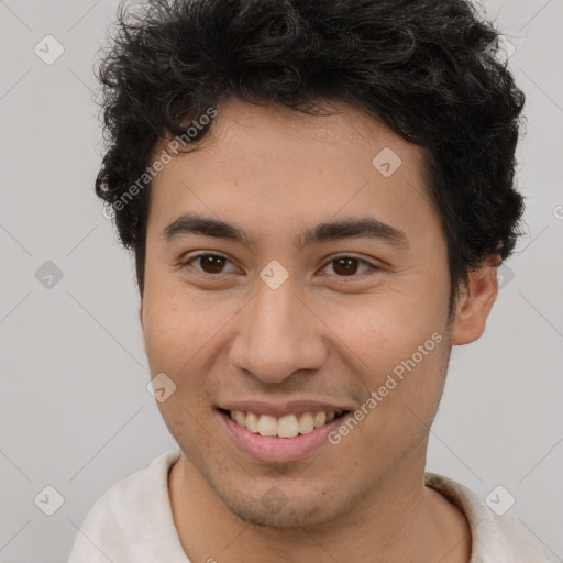 Joyful latino young-adult male with short  brown hair and brown eyes