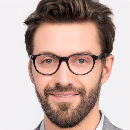 Joyful white adult male with short  brown hair and blue eyes