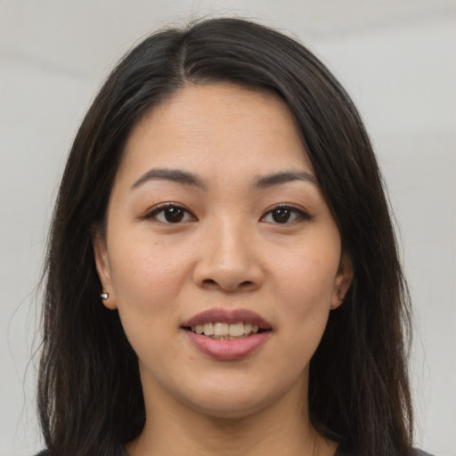 Joyful asian young-adult female with long  brown hair and brown eyes