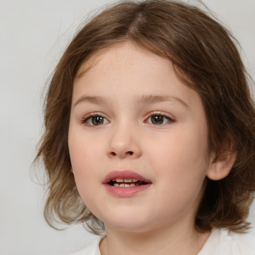 Joyful white child female with medium  brown hair and brown eyes