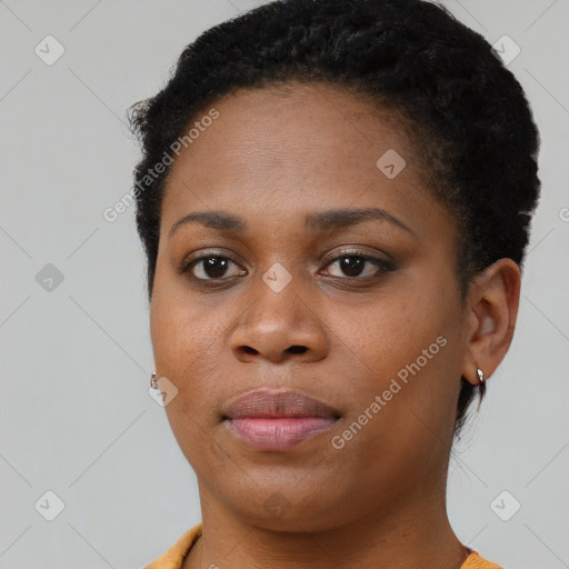 Joyful black young-adult female with short  black hair and brown eyes