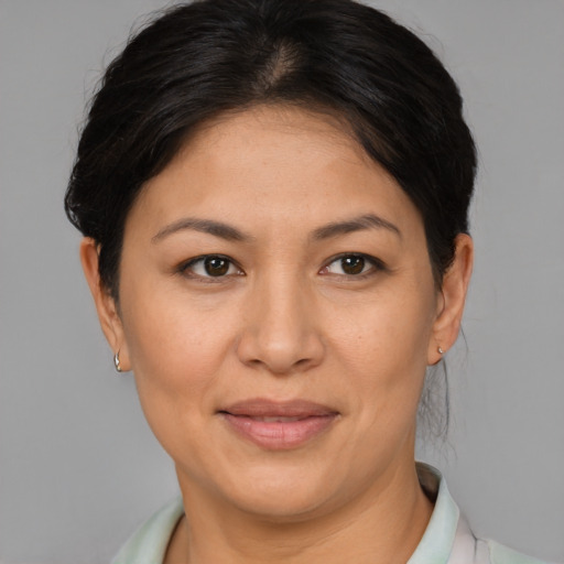 Joyful latino adult female with short  brown hair and brown eyes