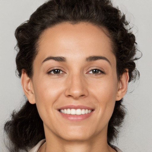 Joyful white young-adult female with medium  brown hair and brown eyes