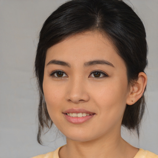 Joyful asian young-adult female with medium  brown hair and brown eyes