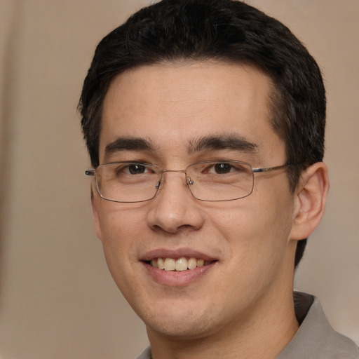 Joyful white young-adult male with short  black hair and brown eyes