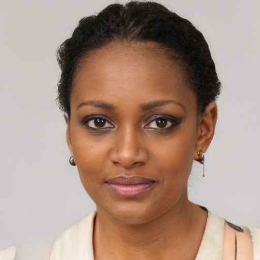 Joyful black young-adult female with short  black hair and brown eyes