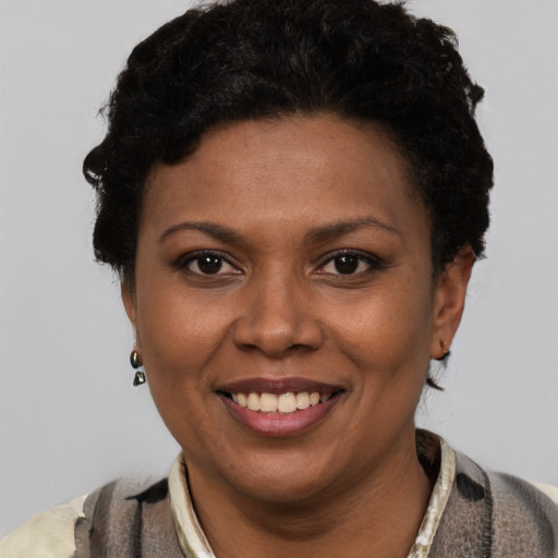 Joyful latino young-adult female with short  black hair and brown eyes