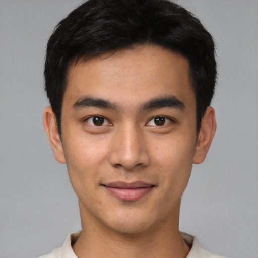 Joyful asian young-adult male with short  brown hair and brown eyes