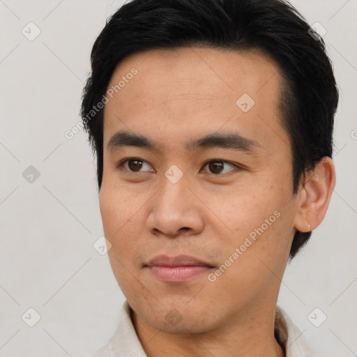 Joyful asian young-adult male with short  brown hair and brown eyes