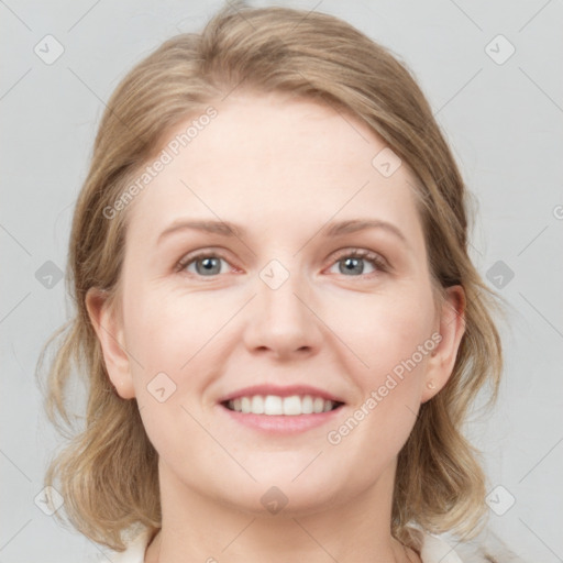 Joyful white young-adult female with medium  brown hair and blue eyes