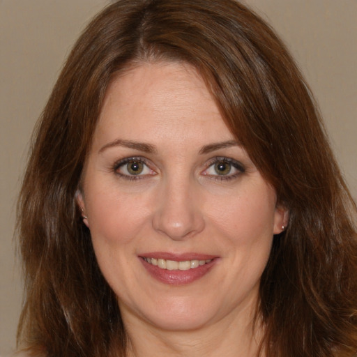 Joyful white adult female with medium  brown hair and brown eyes