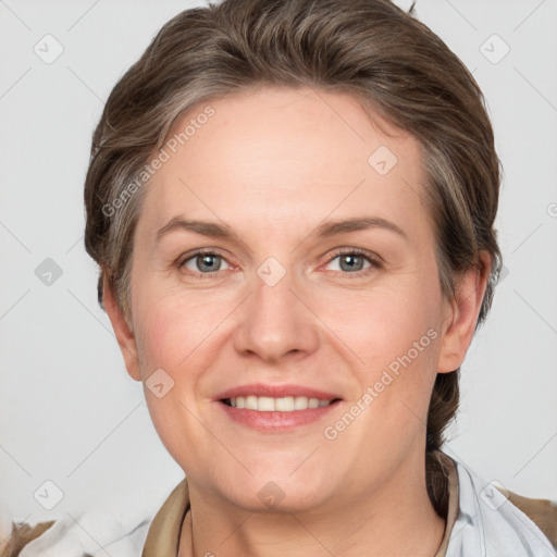 Joyful white adult female with short  brown hair and grey eyes