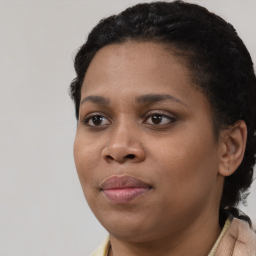 Joyful black young-adult female with short  brown hair and brown eyes