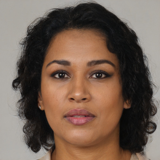 Neutral latino adult female with medium  brown hair and brown eyes