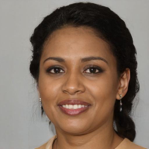 Joyful black young-adult female with medium  black hair and brown eyes