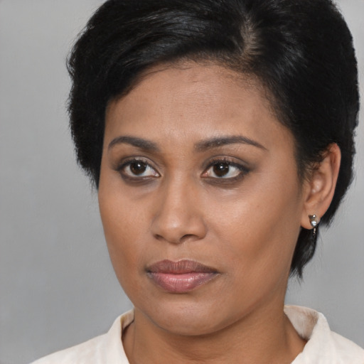 Joyful asian young-adult female with short  brown hair and brown eyes