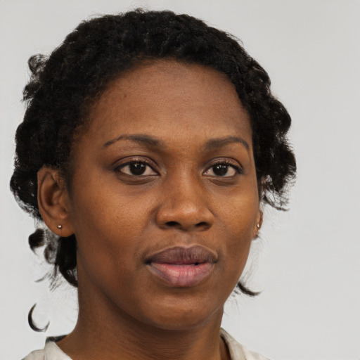 Joyful black adult female with short  brown hair and brown eyes