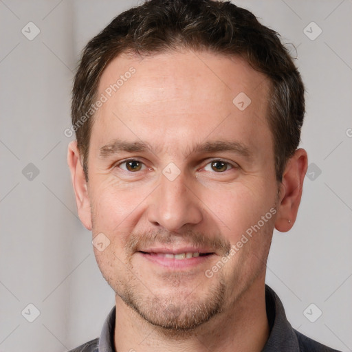 Joyful white adult male with short  brown hair and brown eyes