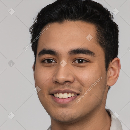 Joyful latino young-adult male with short  black hair and brown eyes