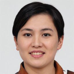 Joyful asian young-adult female with short  brown hair and brown eyes