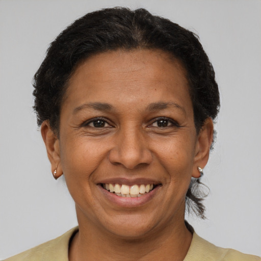 Joyful latino adult female with short  brown hair and brown eyes