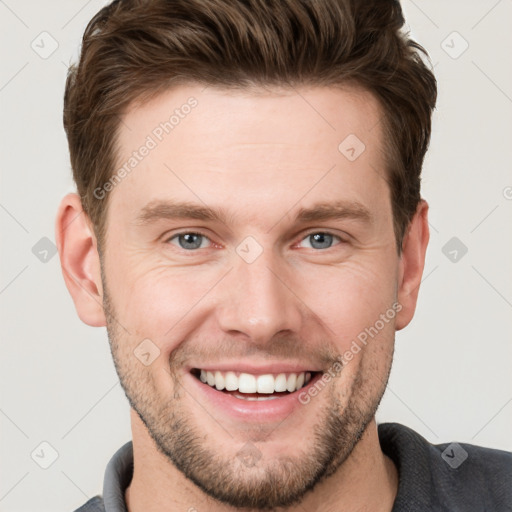 Joyful white young-adult male with short  brown hair and grey eyes