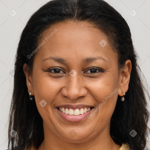 Joyful black adult female with long  brown hair and brown eyes