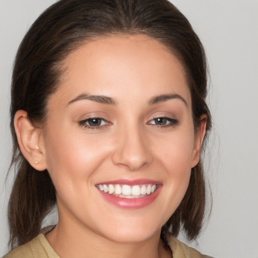 Joyful white young-adult female with medium  brown hair and brown eyes