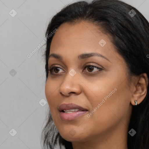 Joyful black adult female with long  black hair and brown eyes