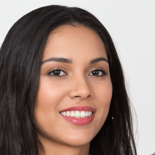 Joyful latino young-adult female with long  brown hair and brown eyes