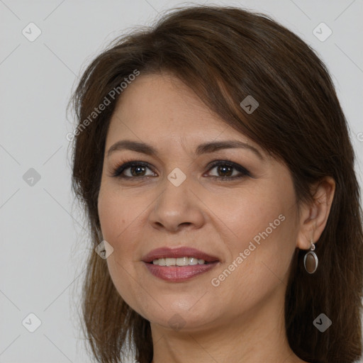 Joyful white adult female with long  brown hair and brown eyes