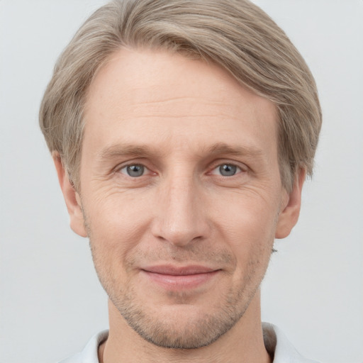 Joyful white adult male with short  brown hair and grey eyes