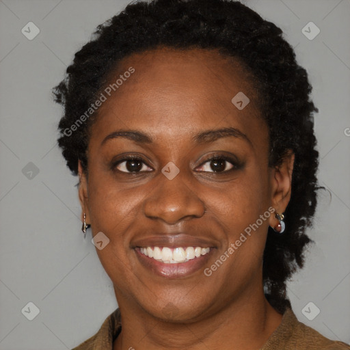 Joyful black adult female with medium  brown hair and brown eyes