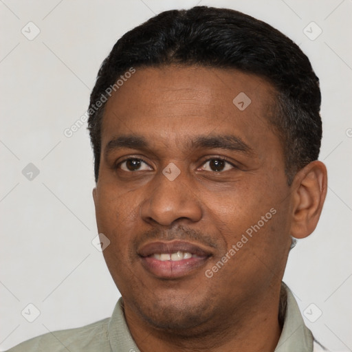 Joyful black young-adult male with short  black hair and brown eyes