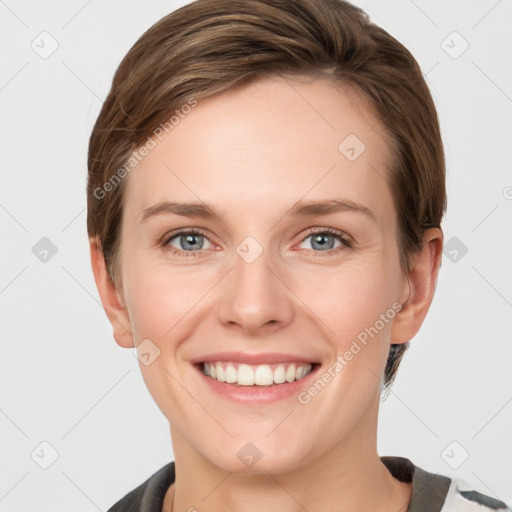 Joyful white young-adult female with short  brown hair and grey eyes