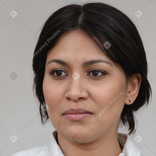 Joyful latino adult female with medium  brown hair and brown eyes