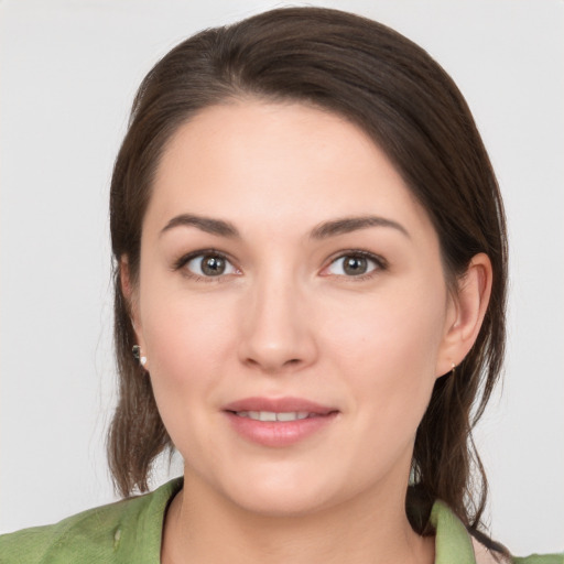 Joyful white young-adult female with medium  brown hair and brown eyes