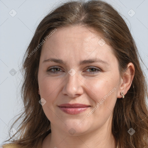 Joyful white adult female with long  brown hair and grey eyes