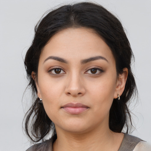 Neutral latino young-adult female with medium  brown hair and brown eyes
