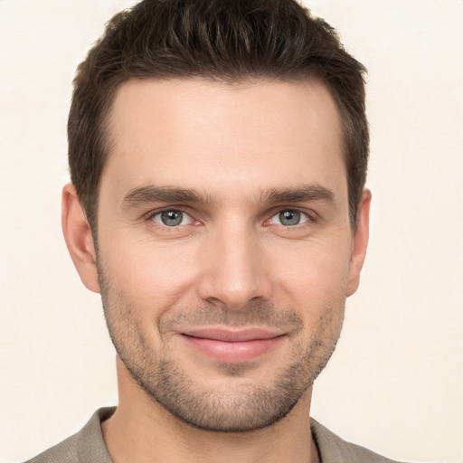 Joyful white young-adult male with short  brown hair and brown eyes