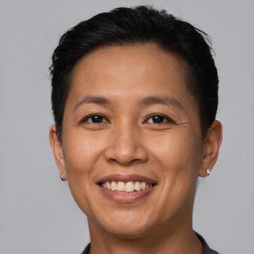 Joyful white adult female with short  black hair and brown eyes
