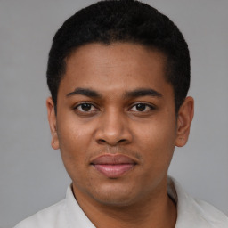 Joyful latino young-adult male with short  black hair and brown eyes