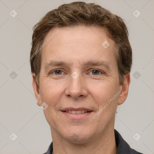 Joyful white adult male with short  brown hair and grey eyes