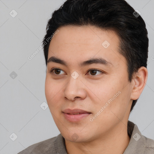 Joyful white young-adult male with short  black hair and brown eyes