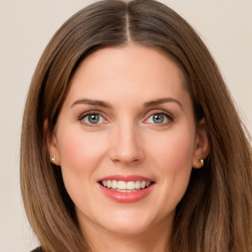 Joyful white young-adult female with long  brown hair and green eyes